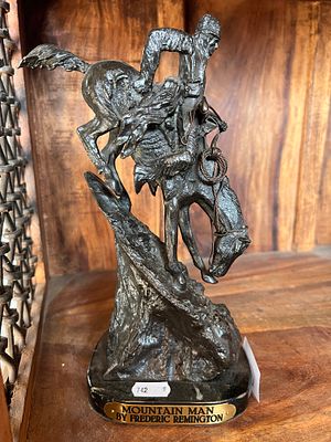 A bronze figure by Frederic Remington titled Mountain man. 27cm tall