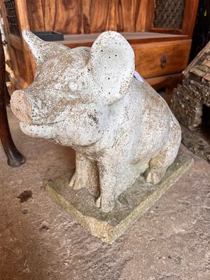 A concrete garden figure of a pig. 37cm tall.