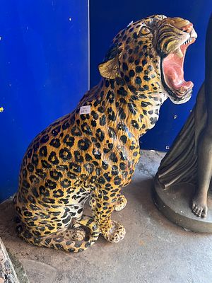 A mid century Italian terracotta life size figure of a Jaguar, hand decorated and glazed. 100cm 