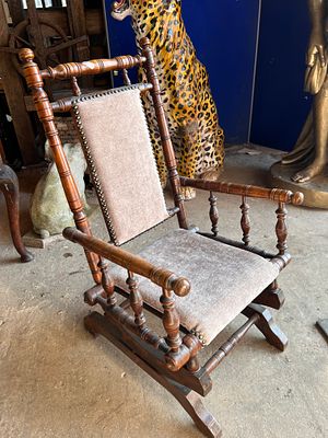 A Victorian child's American-style rocking chair having turned frame.