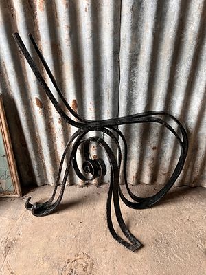 A pair of wrought iron garden bench ends.