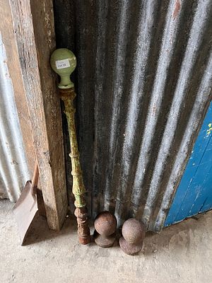 A pair of cast iron finials and similar post.