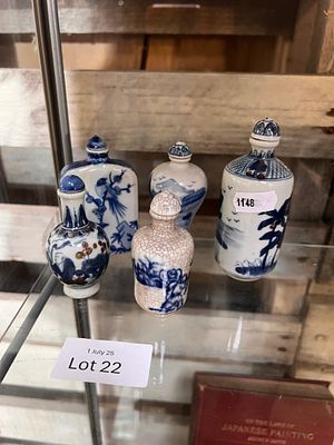A selection of early 20th century Chinese snuff bottles, hand decorated with blue and white 