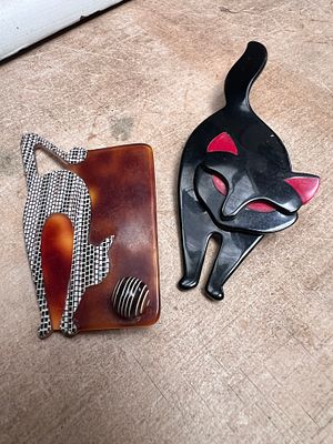 Two Lea Stein Art Deco cat brooches, Paris.