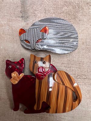 Two Lea Stein Art Deco cat brooches, Paris.