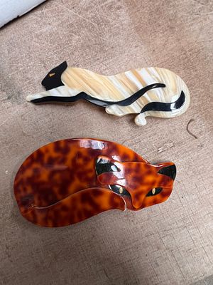 Two Lea Stein Art Deco cat brooches, Paris.