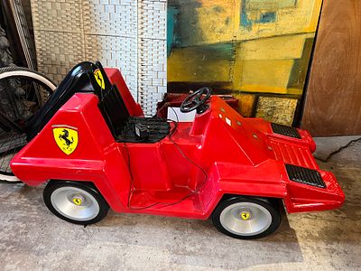 A vintage 1970's arcade machine space car ride, having been repainted for Ferrari. 135cm long 
