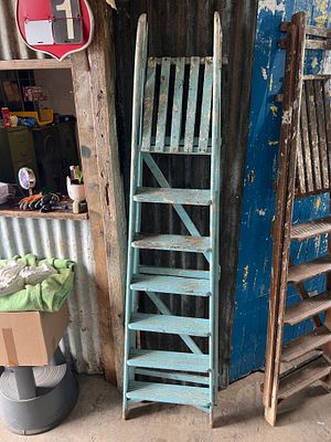 A pair of light blue painted step ladders and similar.
