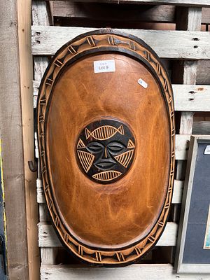 An African tribal wood carved shield. 55cm long.