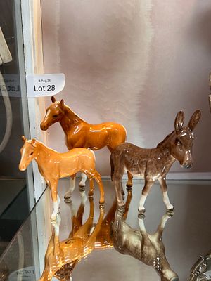 Three Beswick figure studies including Palomino pony, Donkey and Foal having had repair to leg.