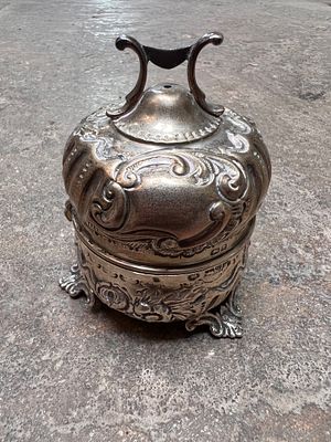 A Victorian HM silver string box, having chase work and floral decoration on tripod base. 101g 