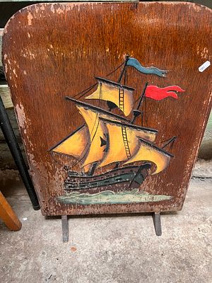 An Art Deco fire screen with ship image.
