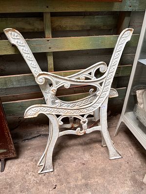 A pair of vintage cast iron bench ends.