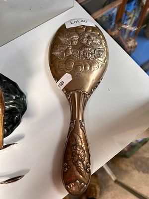 An early 20th century HM silver make up mirror, decorated with embossed cherub design.