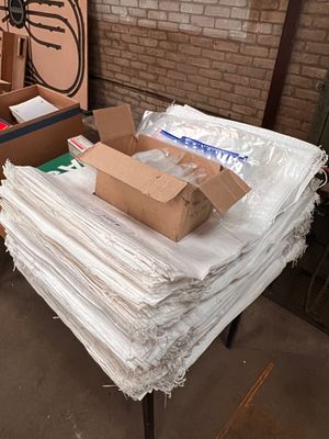 A collection of white hessian bags approximately 700 and 500 quick lock plastic bags.