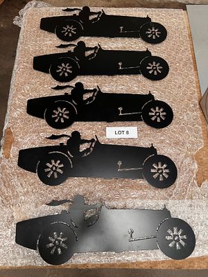 Five metal racing car cut-outs powder-coated black.