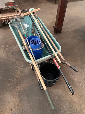 A wheelbarrow complete with rake, spring bock, mop and buckets etc