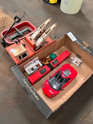 A box of toys to include vintage Tonka toys tow truck