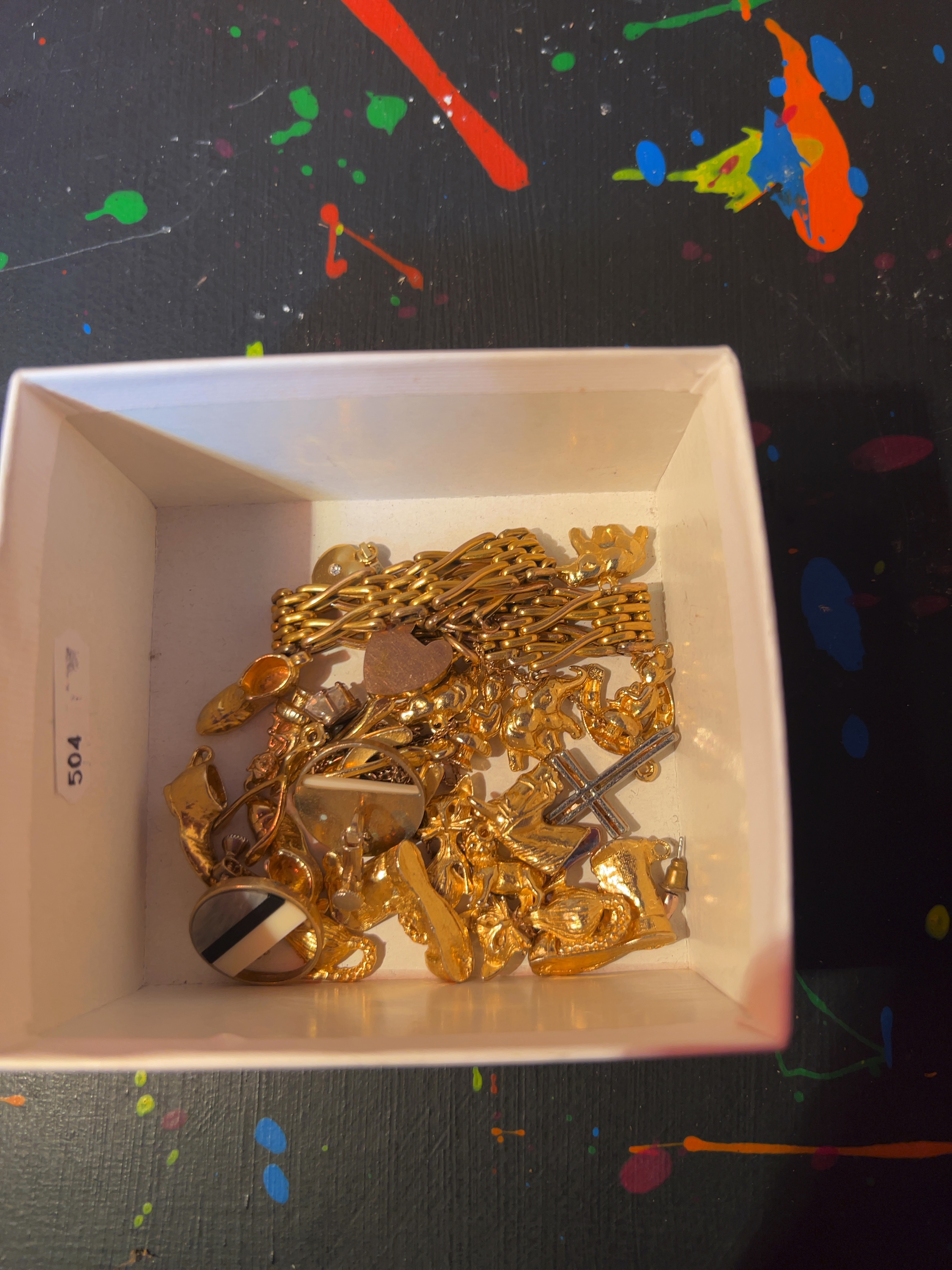 A Collection of Yellow Metal Jewellery Including a Gate Link Bracelet and Assorted Charms