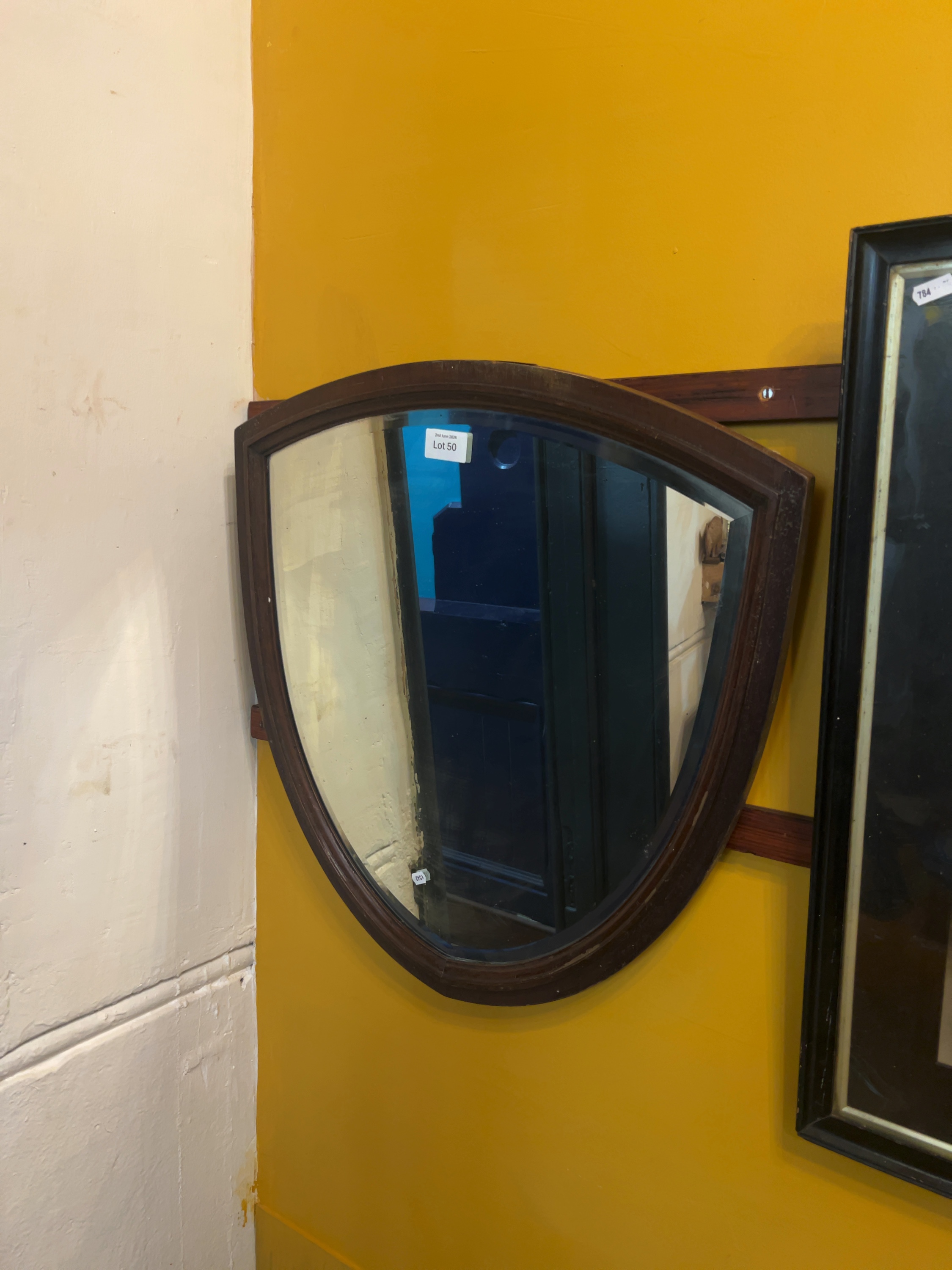 Mid-20th-century shield-shaped wall mirror with bevelled glass