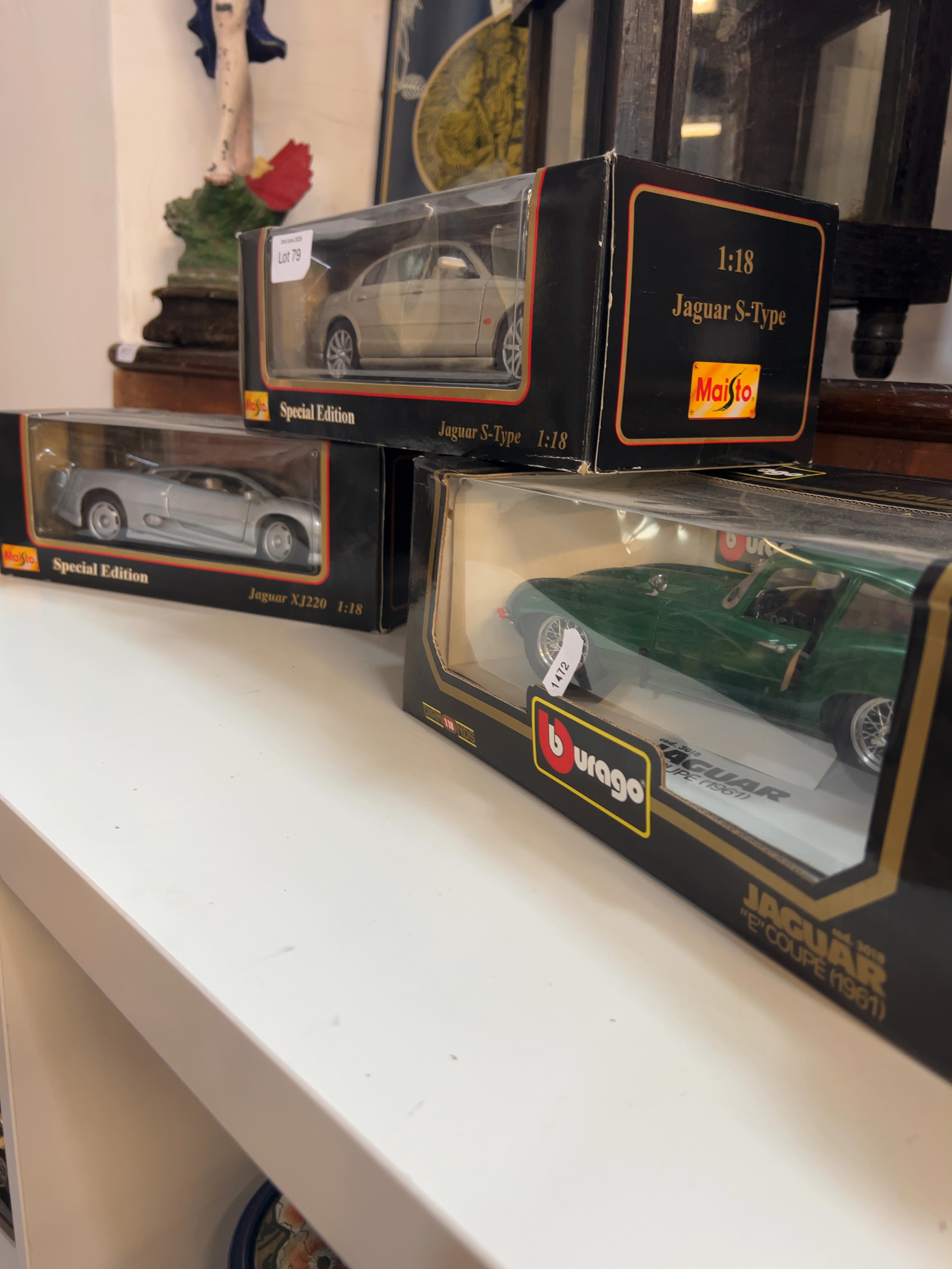 Three 1:18 scale die-cast model Jaguar cars by Maisto and Bburago