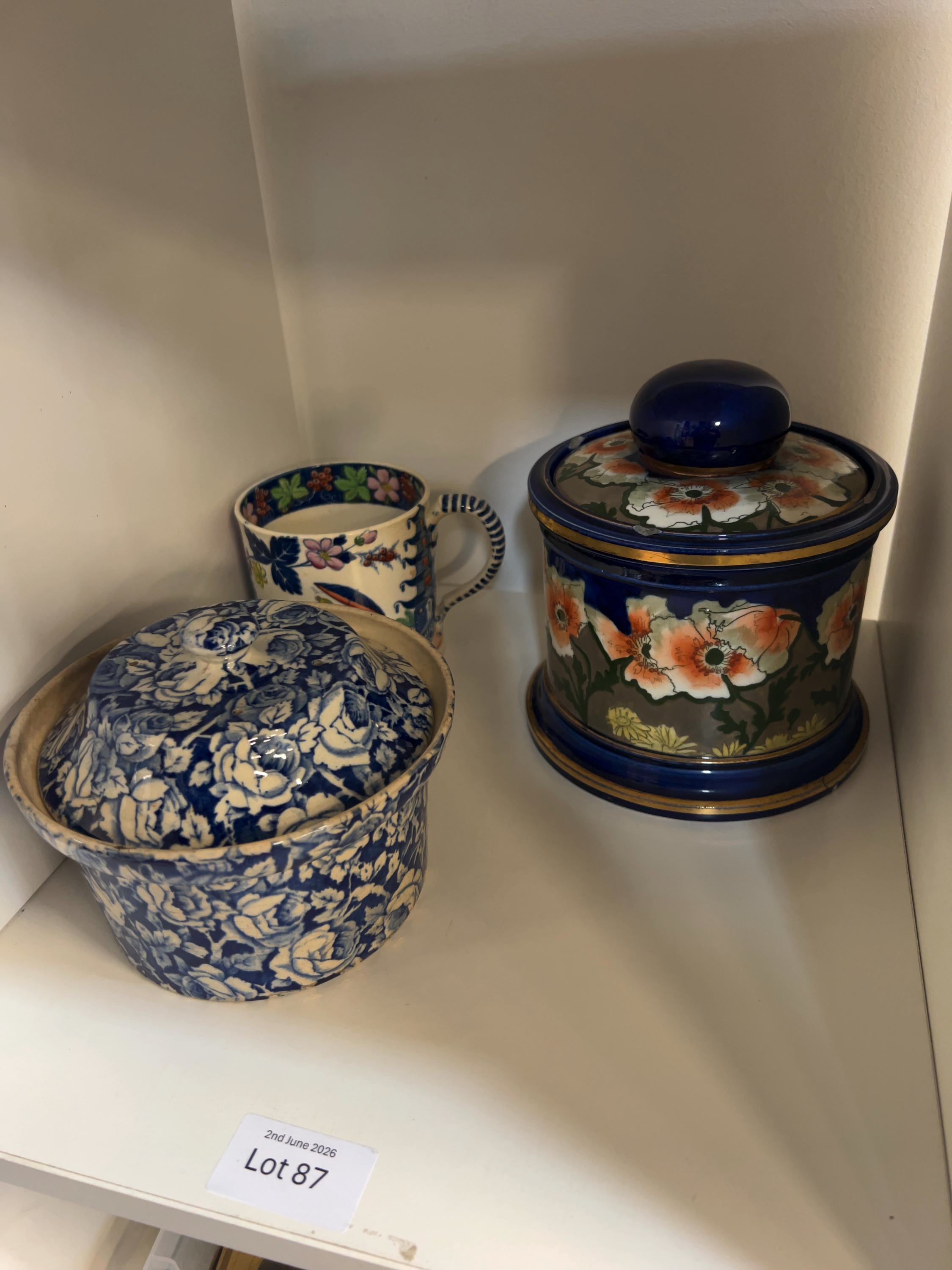 Three Assorted Ceramics including a Blue and White Floral Lidded Pot, an Art Pottery Jar and a Chinoiserie Mug