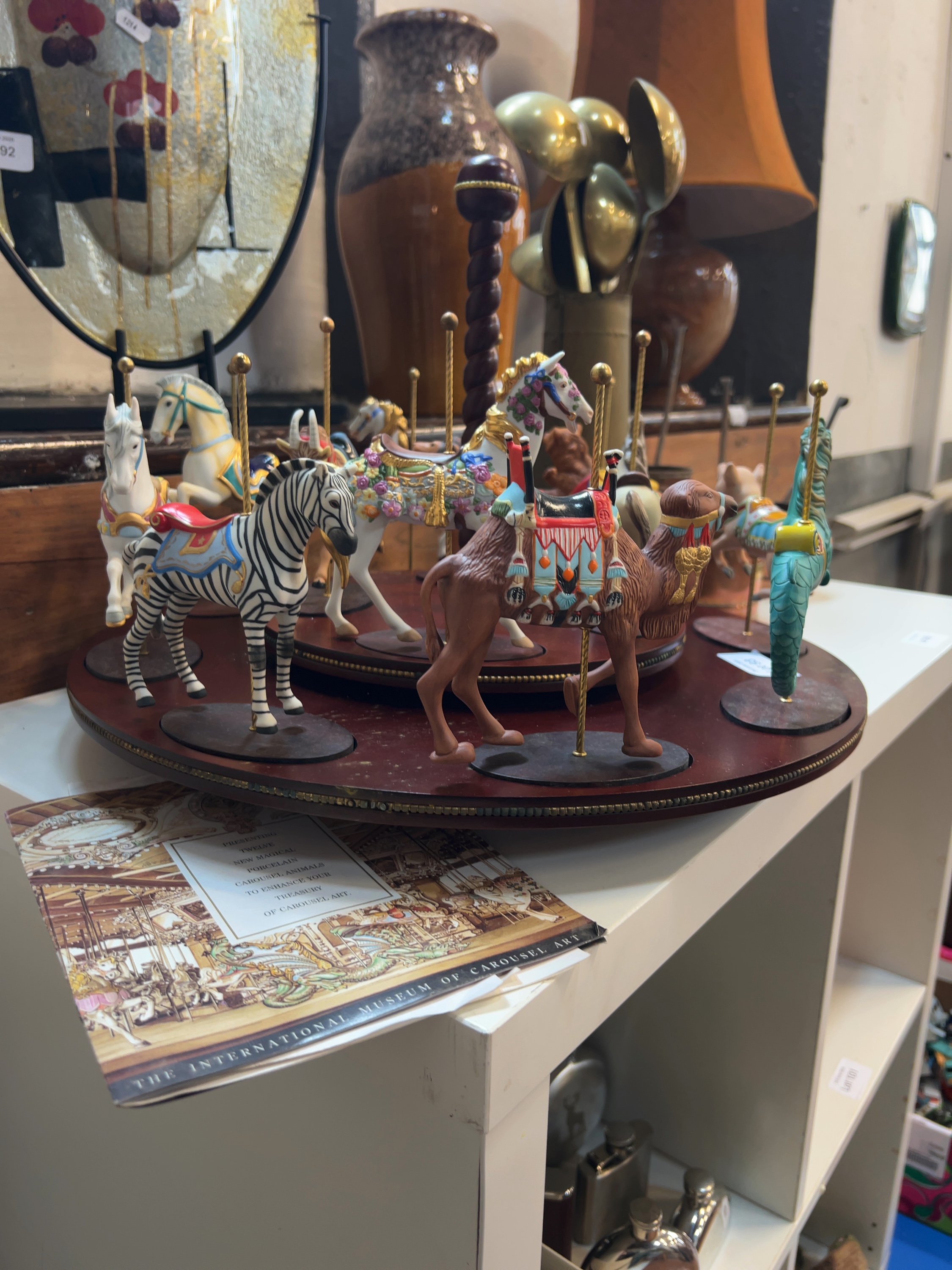 A Collection of Twelve Franklin Mint Treasury of Carousel Art Porcelain Figurines and Display Stand
