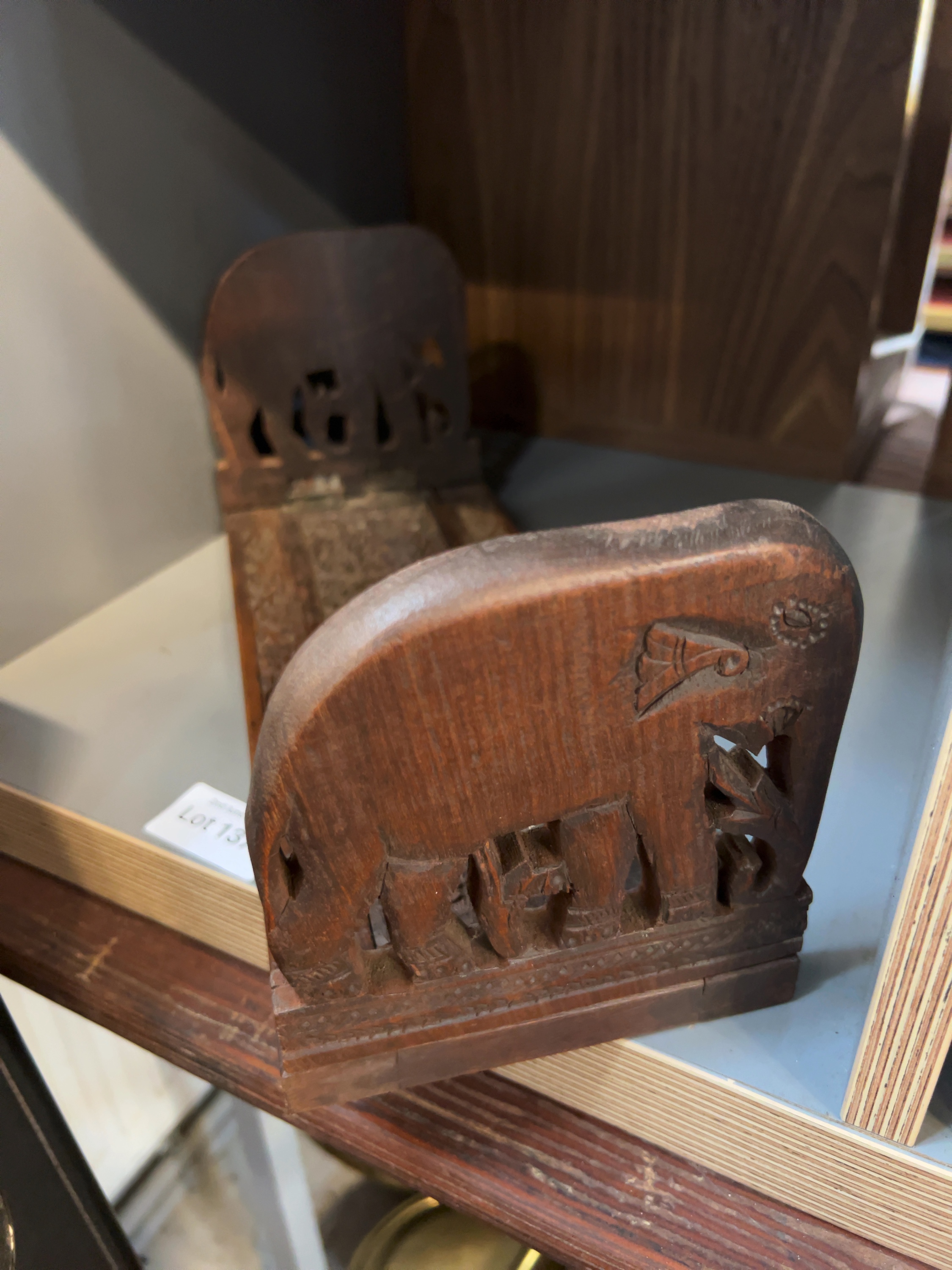 An Anglo-Indian Carved Hardwood Folding Book Rack with Elephant Terminals