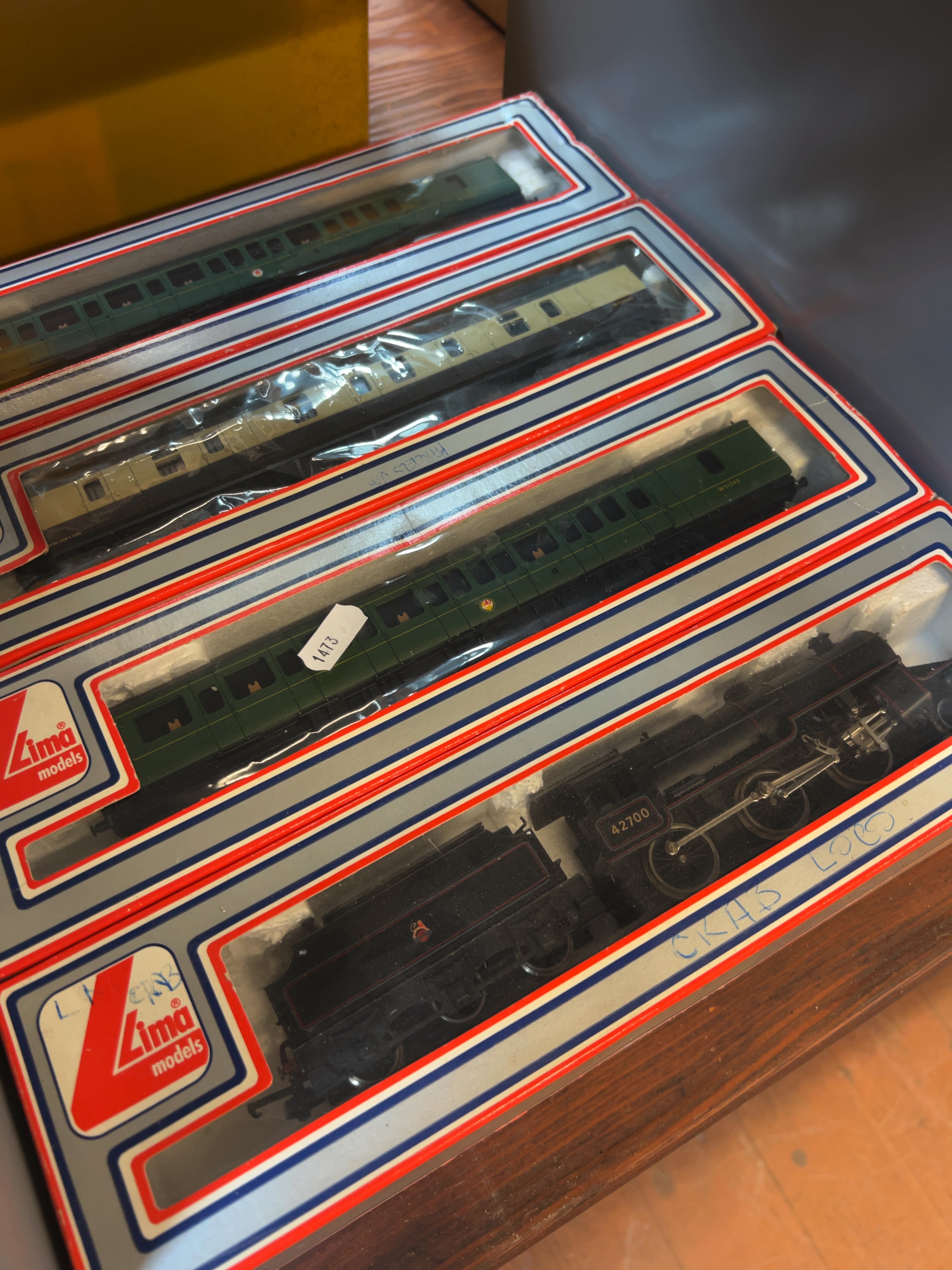 Four Lima OO gauge model railway items comprising a locomotive with tender and three coaches