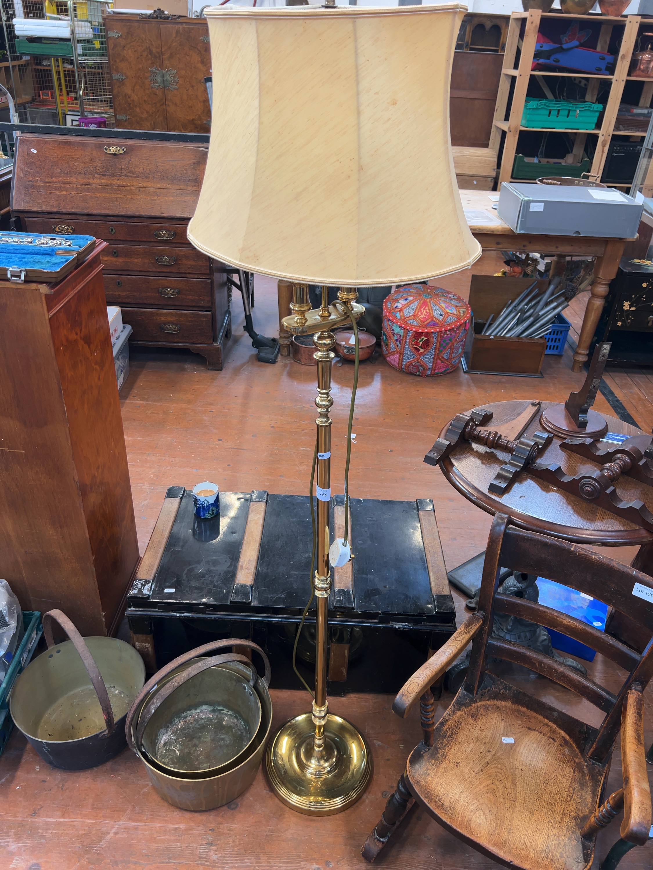 A mid-20th century brass floor lamp with flared fabric shade