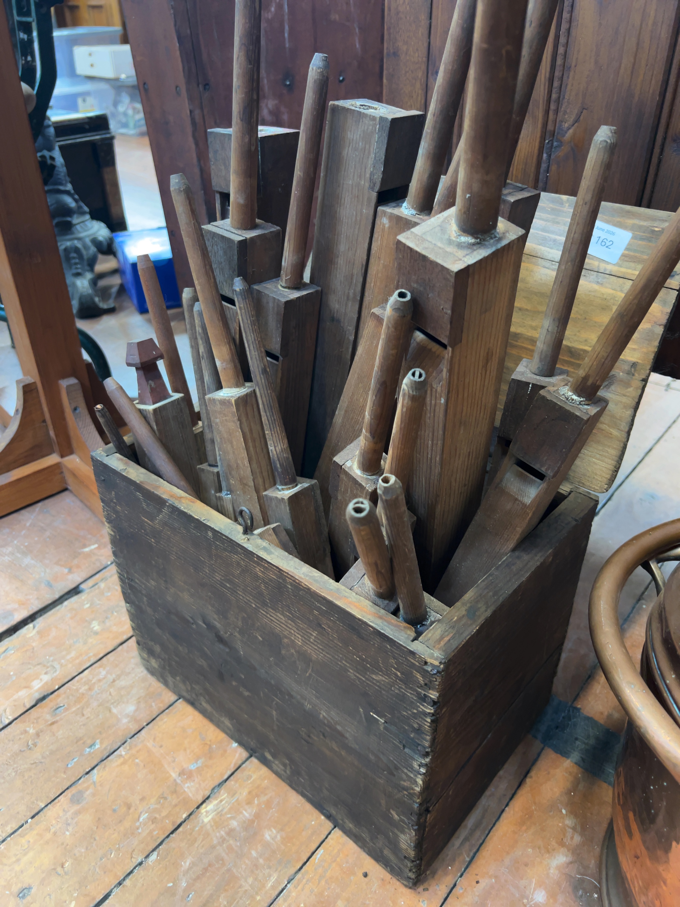 A Group of Antique Wooden Organ Pipes in a Vintage Storage Crate