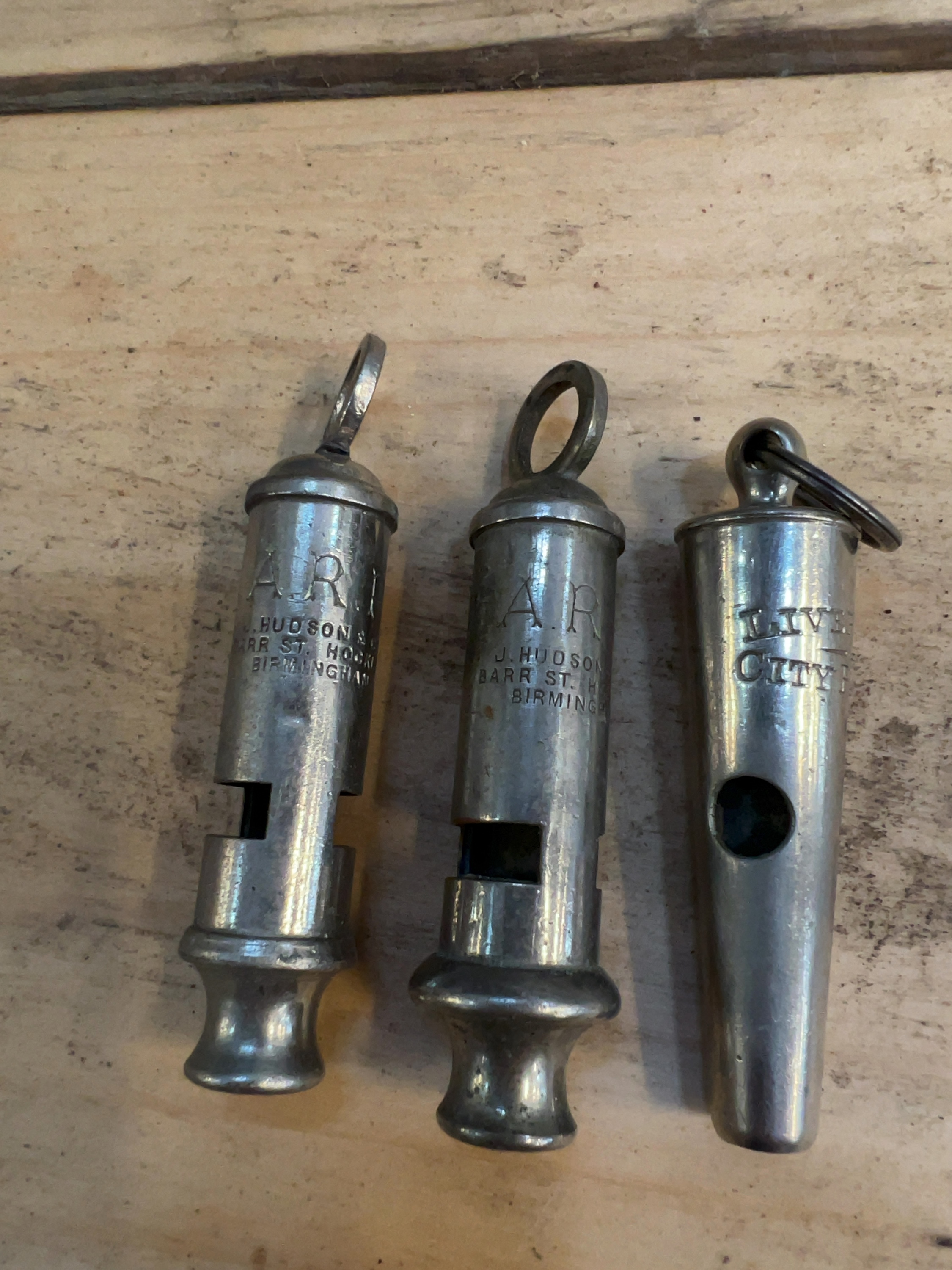 A Trio of Vintage British Service Whistles including J. Hudson and Co Air Raid Precautions and Liverpool City Police Examples