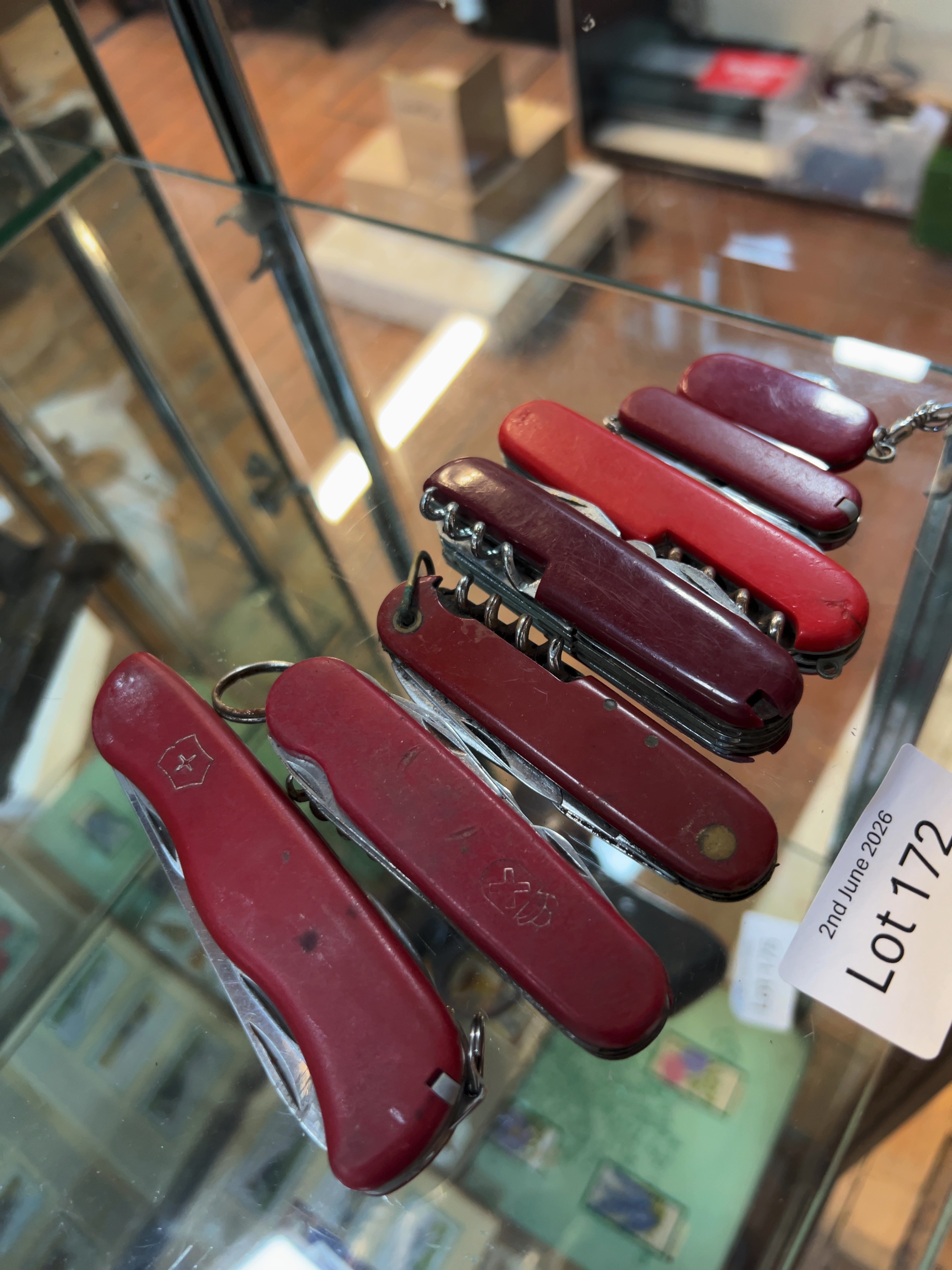 A Collection of Seven Victorinox and Other Swiss Army Style Pocket Knives