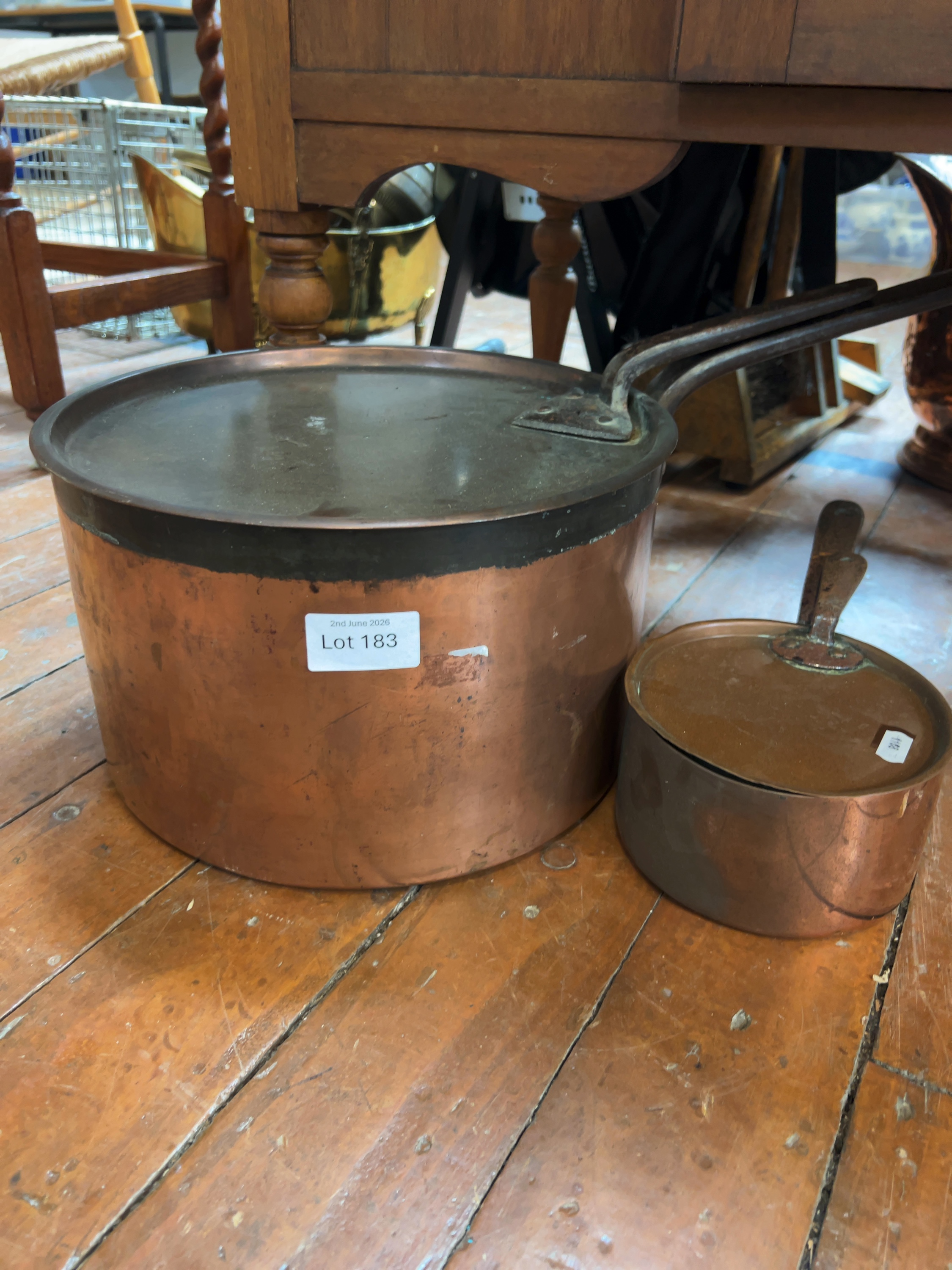 A Pair of Antique Graduated Copper Saucepans with Matching Lids