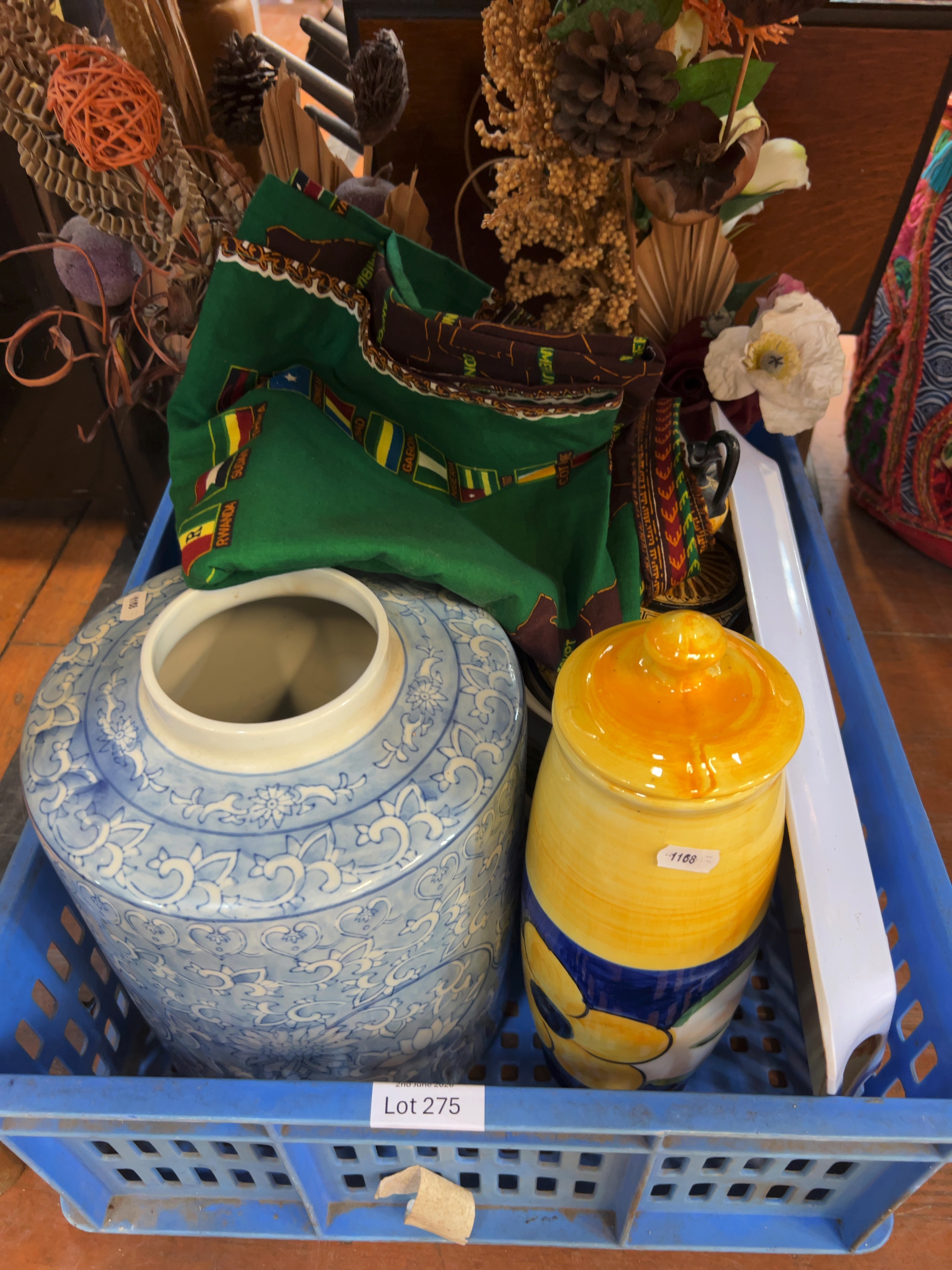An Assortment of Decorative Ceramics, an African Themed Textile, and Dried Botanicals