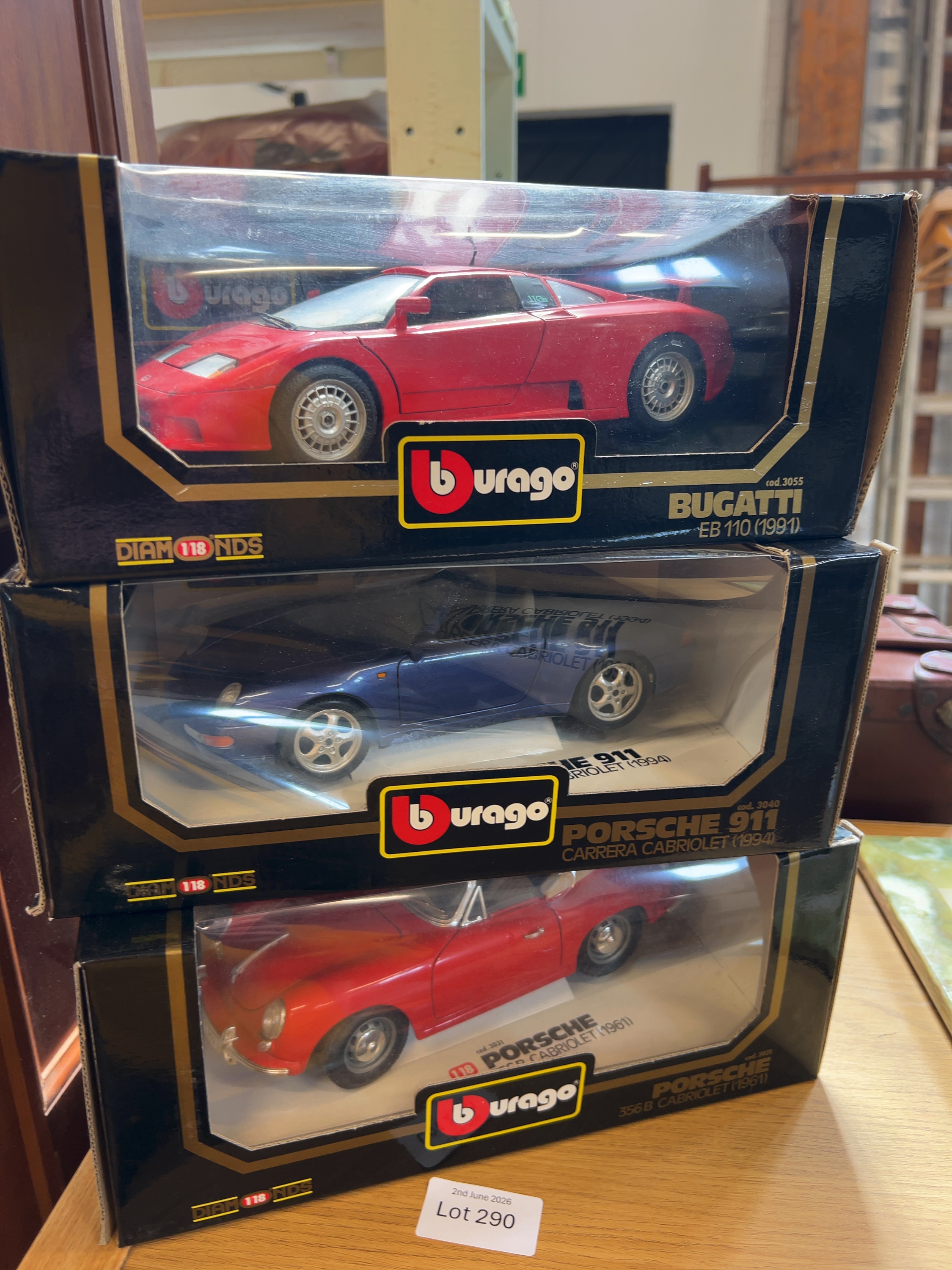 Three Bburago 1:18 Scale Die-Cast Model Cars Including Bugatti and Porsche