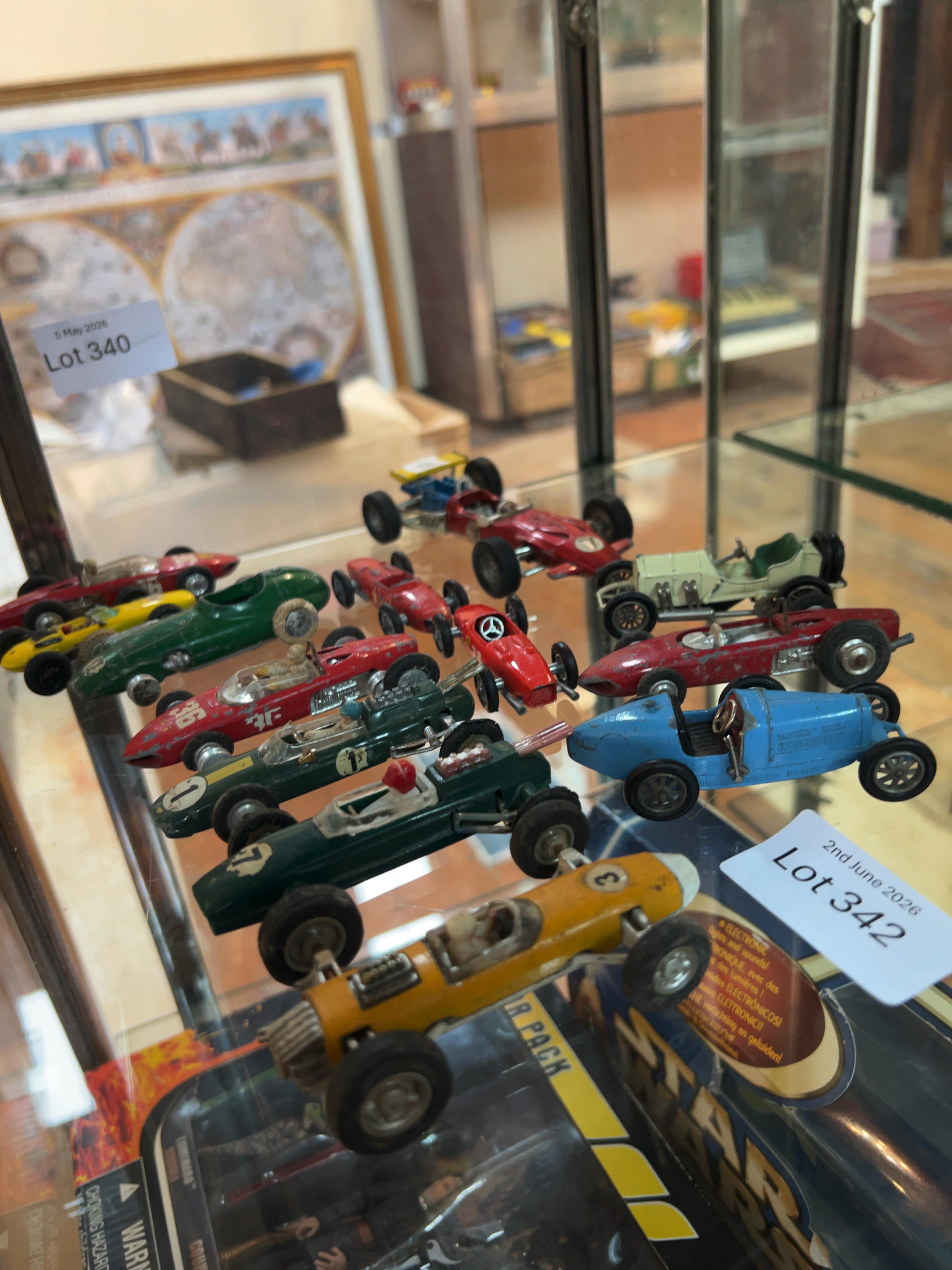 A Collection of approximately 15 vintage die-cast and plastic model racing cars including Formula 1 and Grand Prix styles