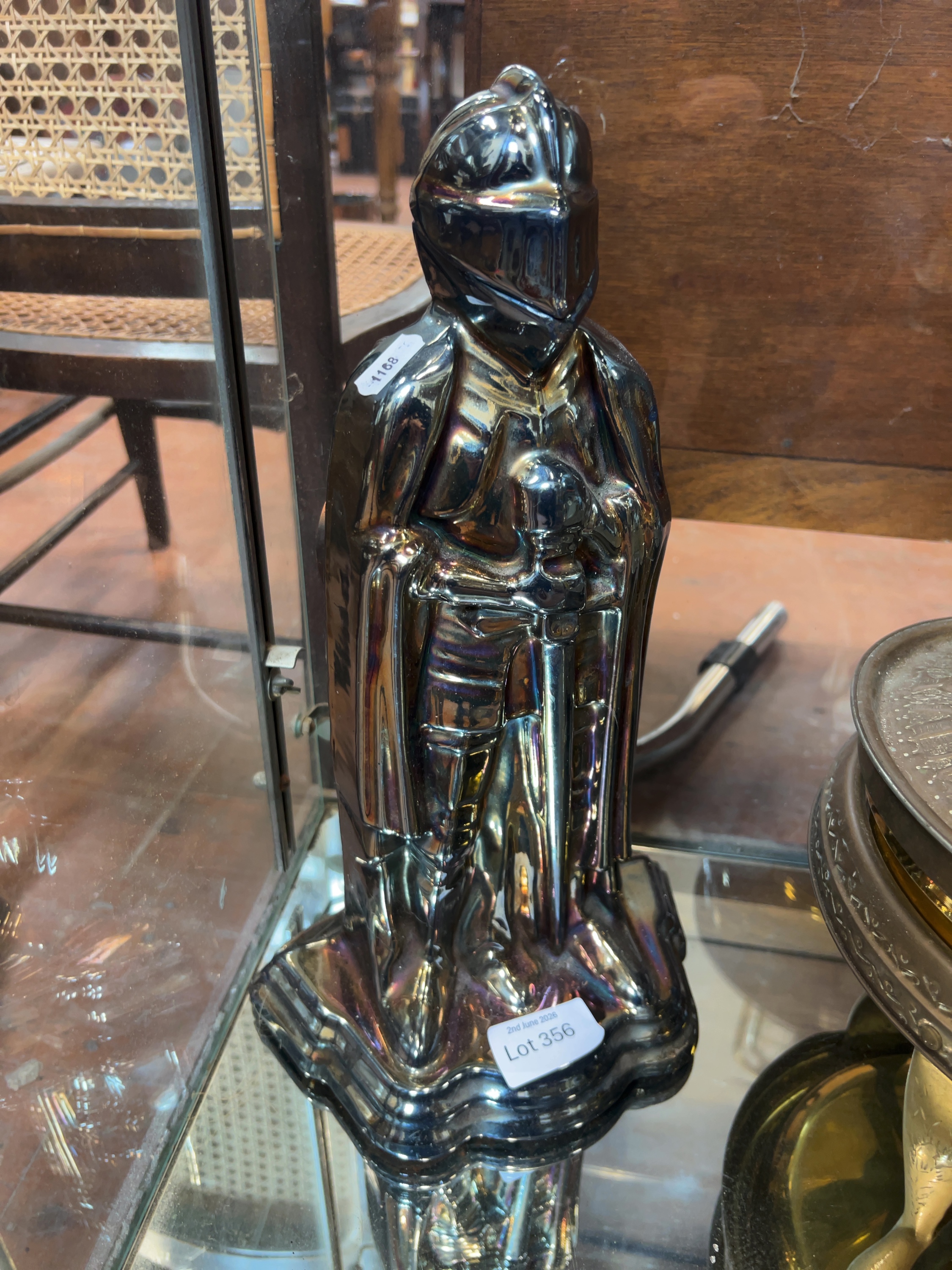 A mid-20th century iridescent cast metal knight fireplace companion set