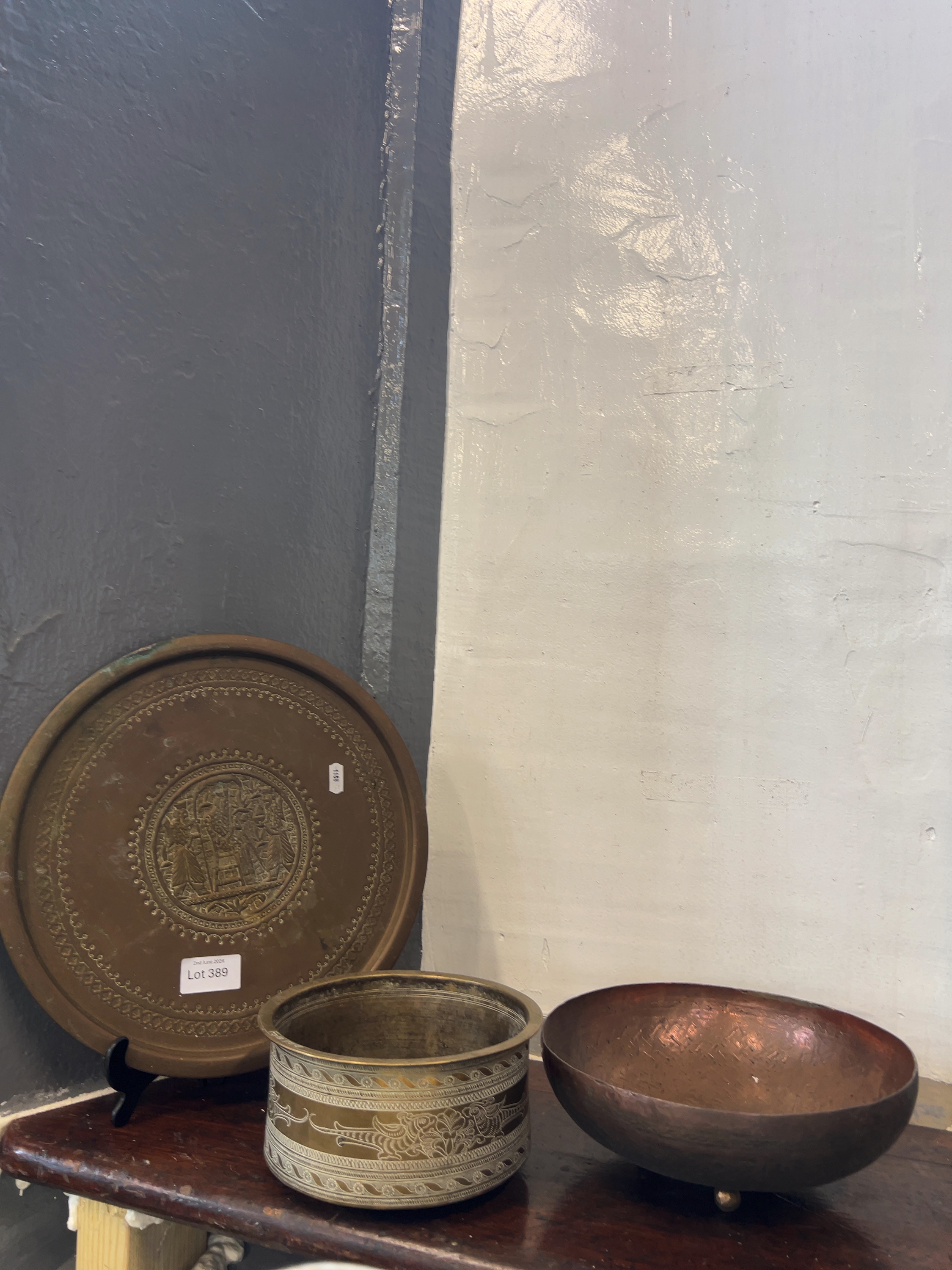 Three Assorted Metalware Items including a Large Brass Charger, a Benares Style Inlaid Bowl, and a Bida Copper Bowl