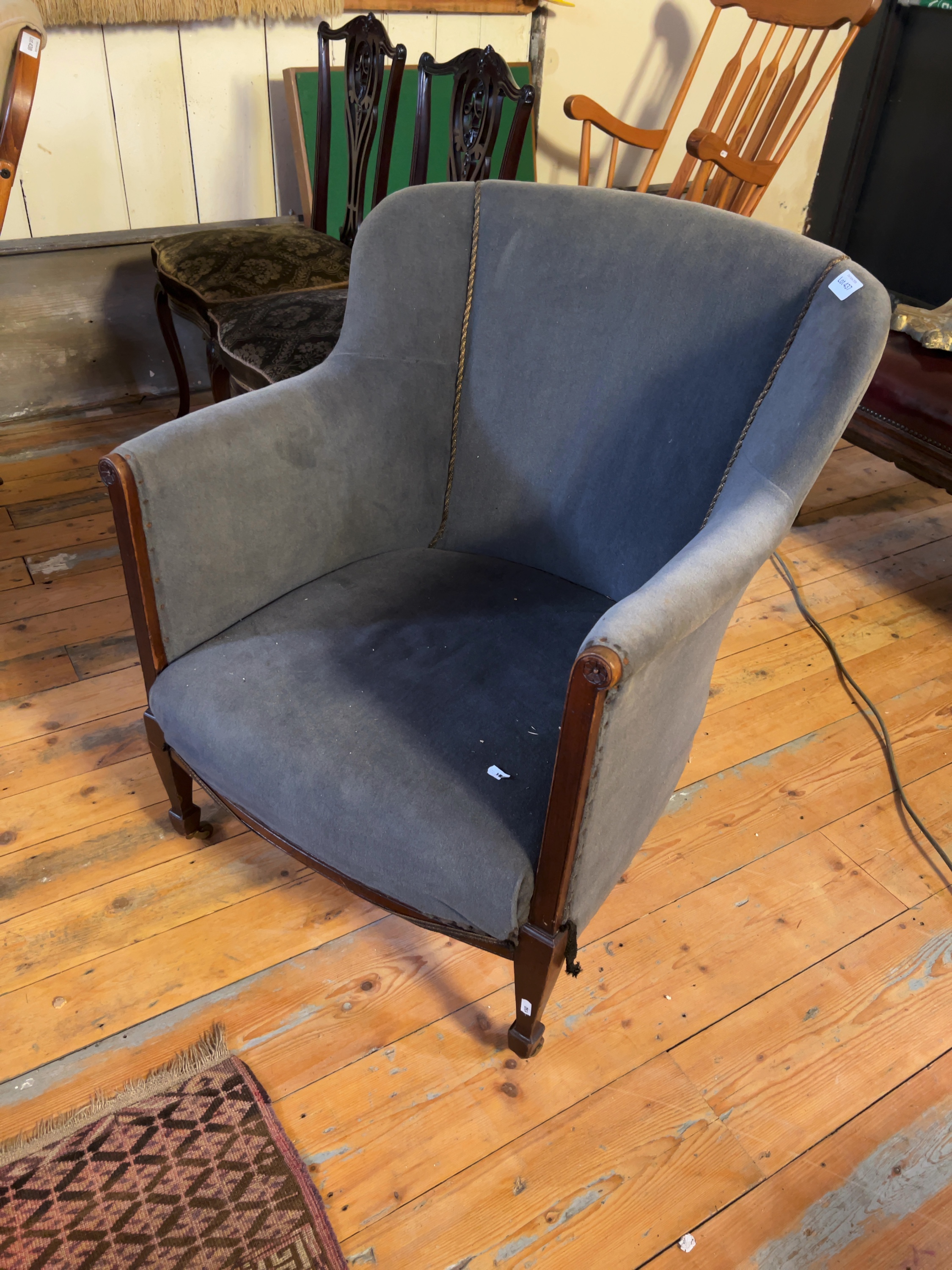 An early 20th-century mahogany and velvet tub-style armchair