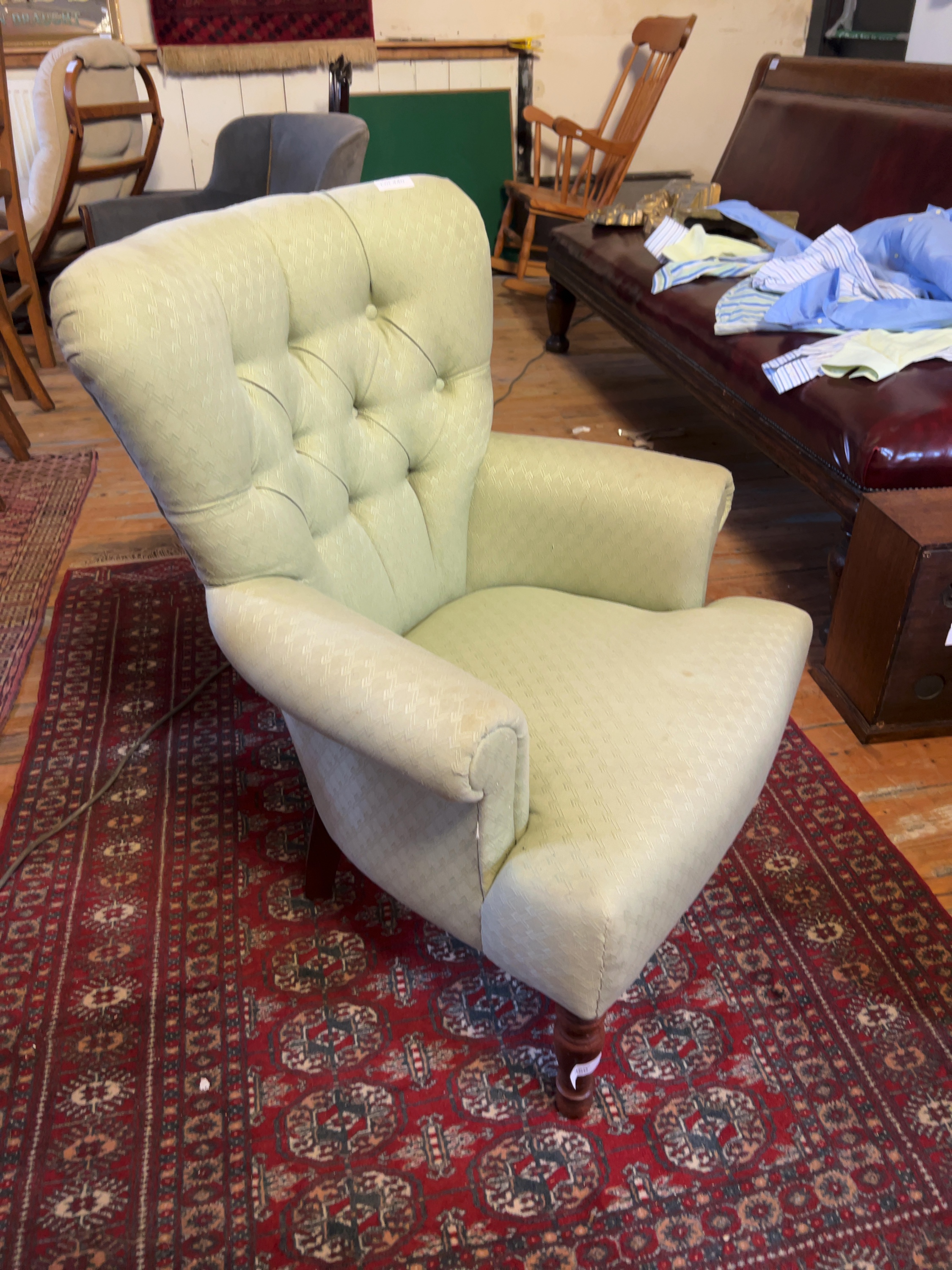 A Victorian style button-back armchair in pale green upholstery