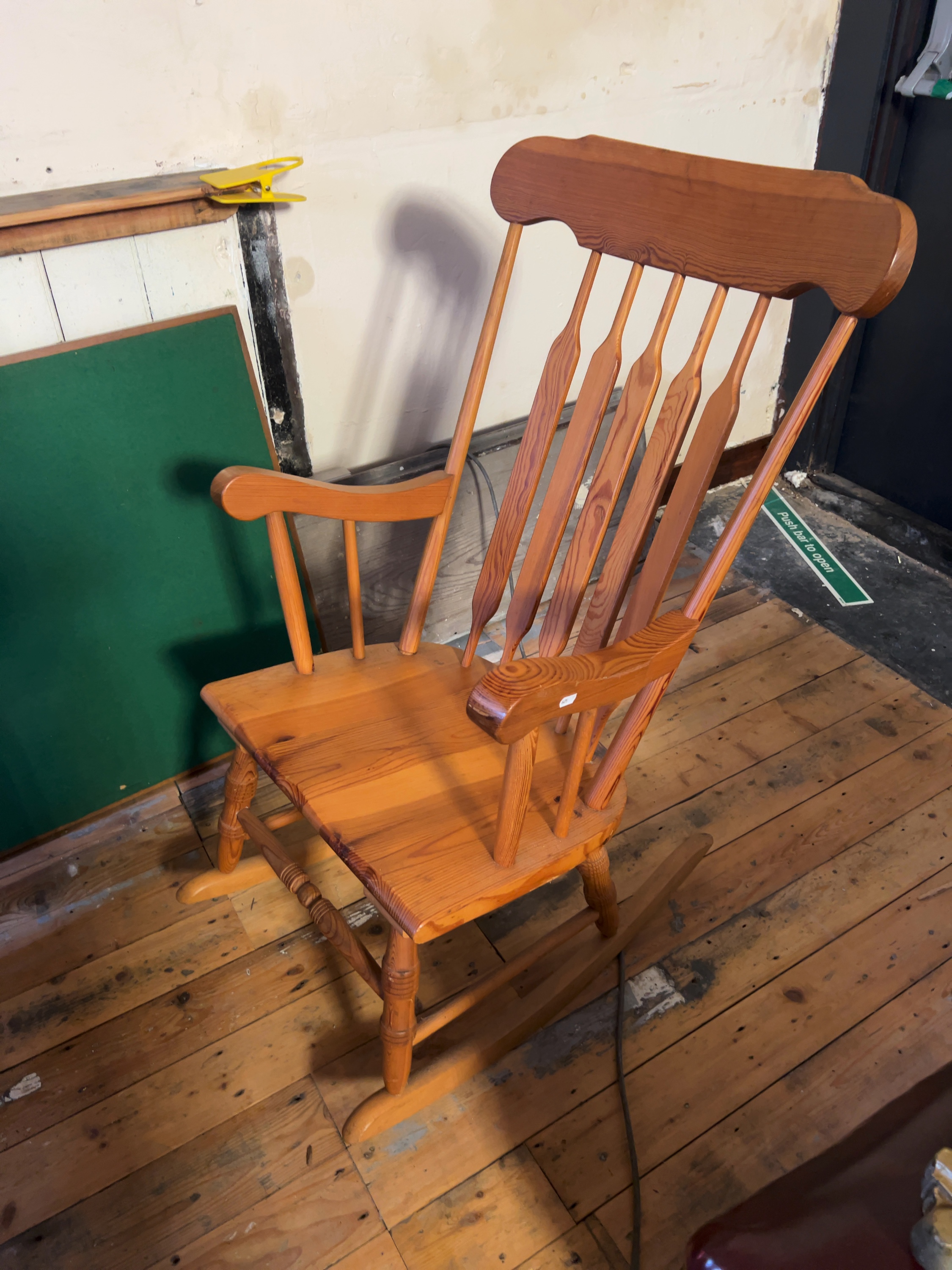 A 20th-century Windsor-style cattail back rocking chair