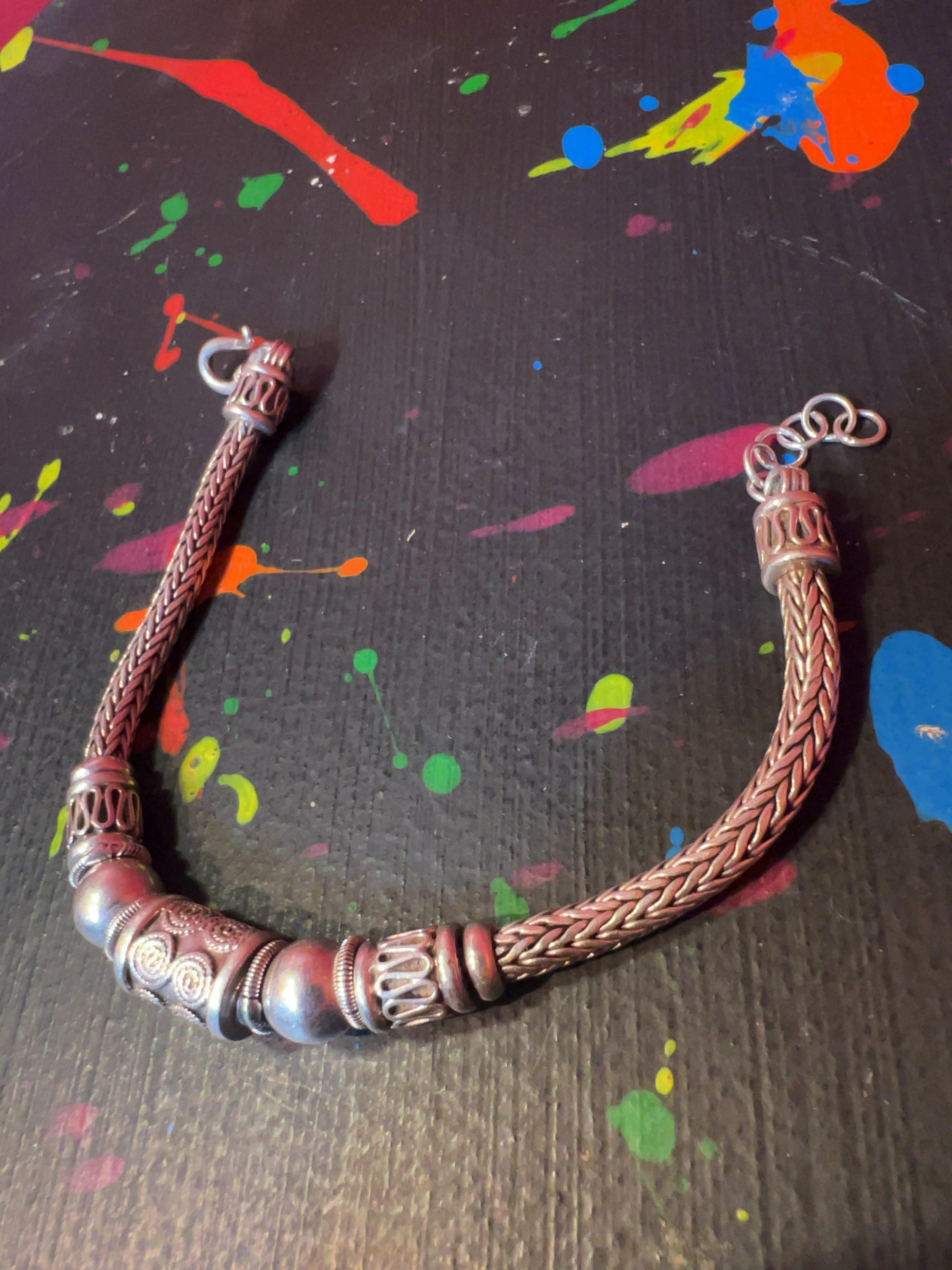 A Bali-style sterling silver woven foxtail chain bracelet with decorative beads