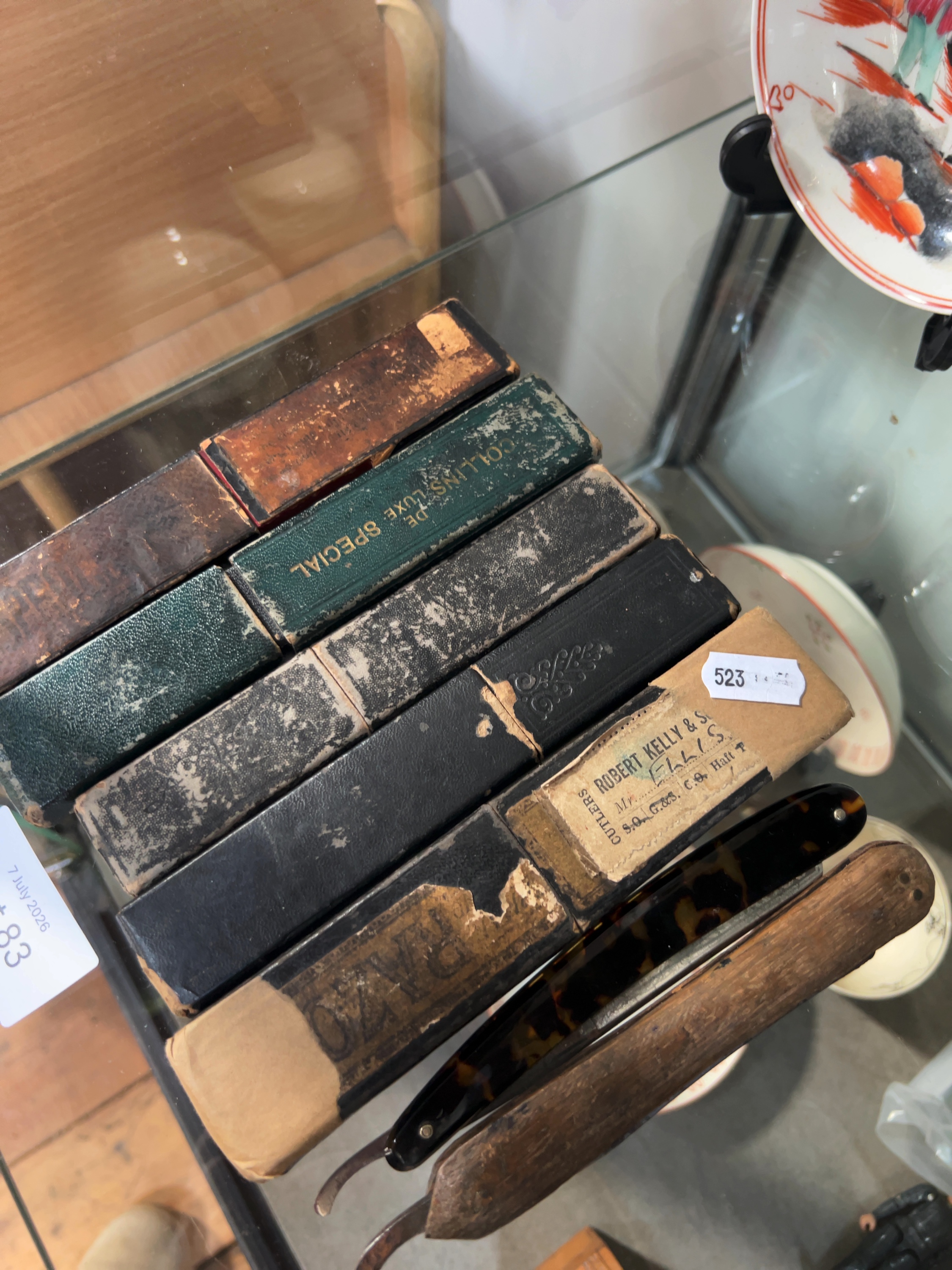 A collection of seven vintage straight razors and five associated cases