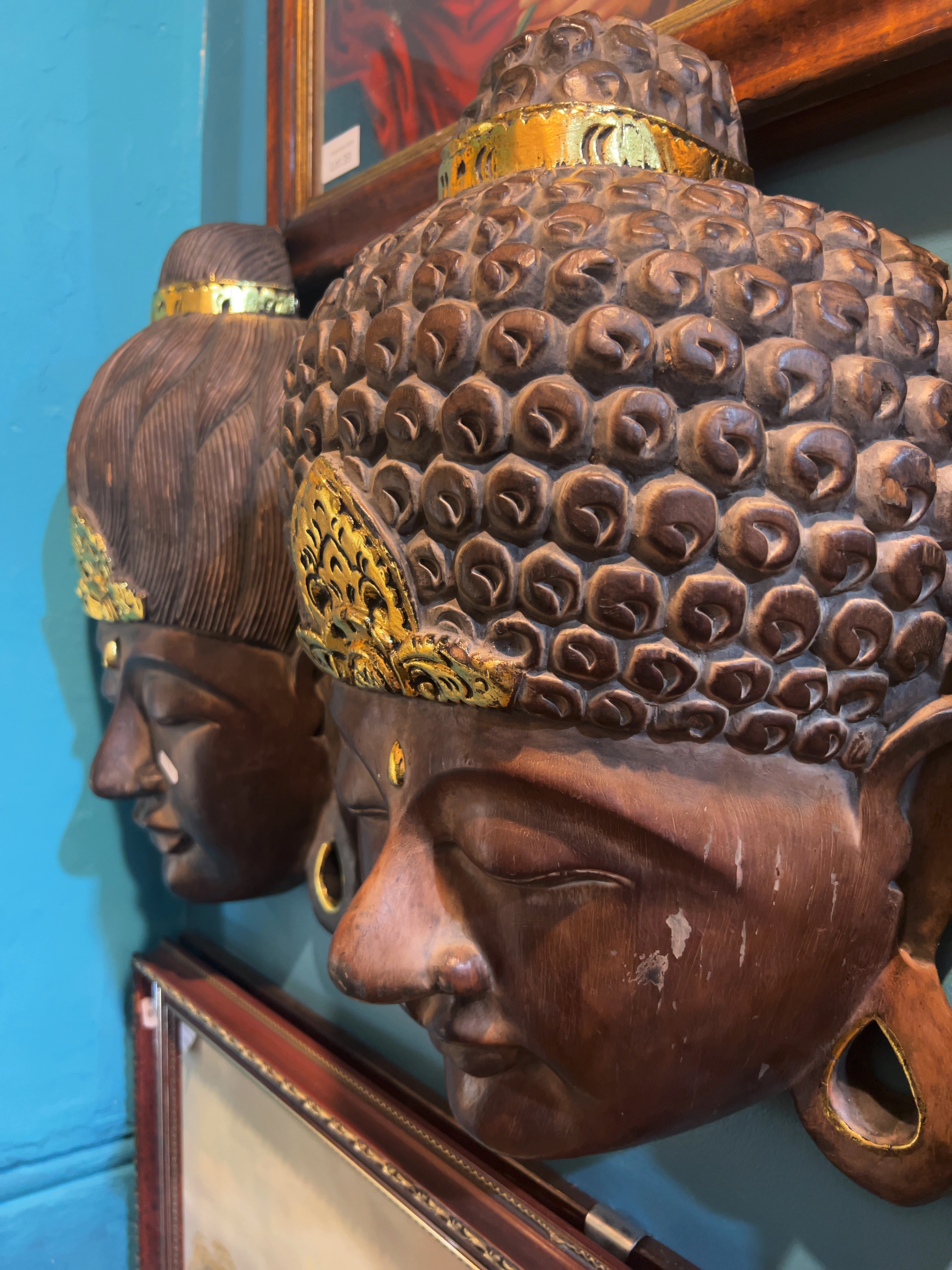 Two Late 20th-century Balinese Carved Wood Gilt Highlighted Wall Masks Depicting Buddha and a Serene Deity