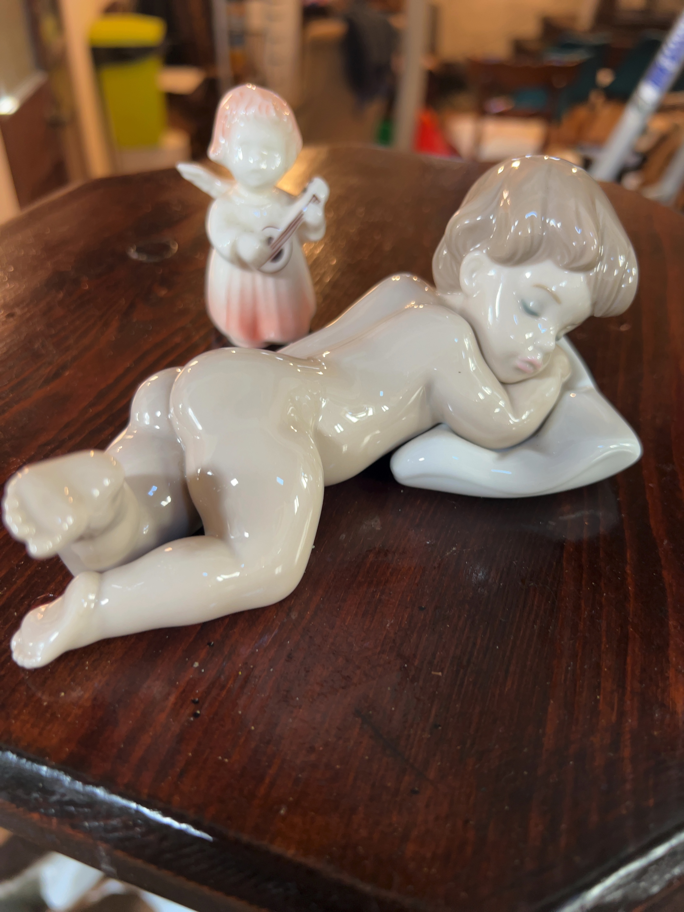 Two Lladró and Goebel Glazed Porcelain Figurines including Sleepy Time Infant and Lute-Playing Angel