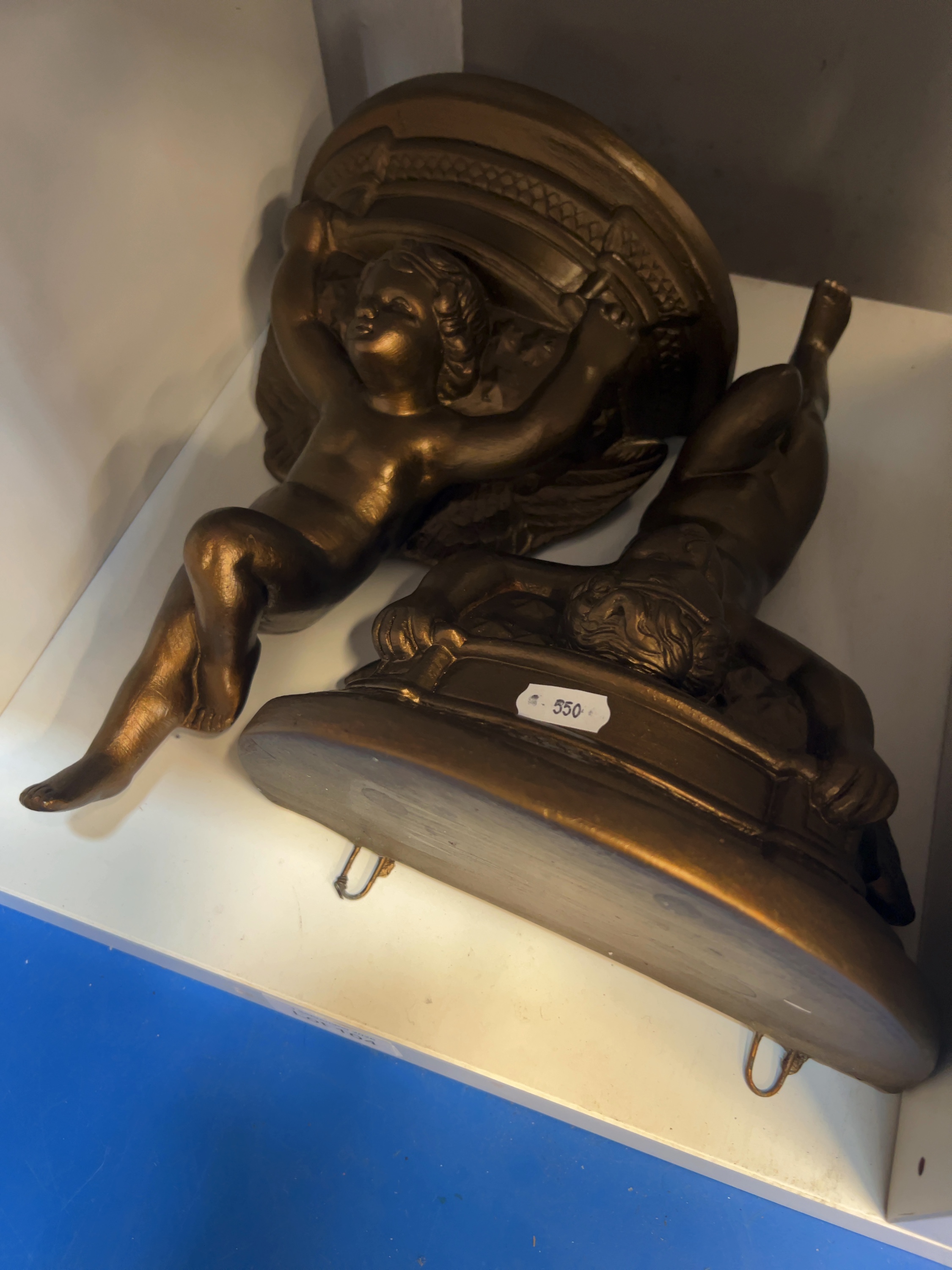 Two Bronzed Composite Cherub Wall Brackets