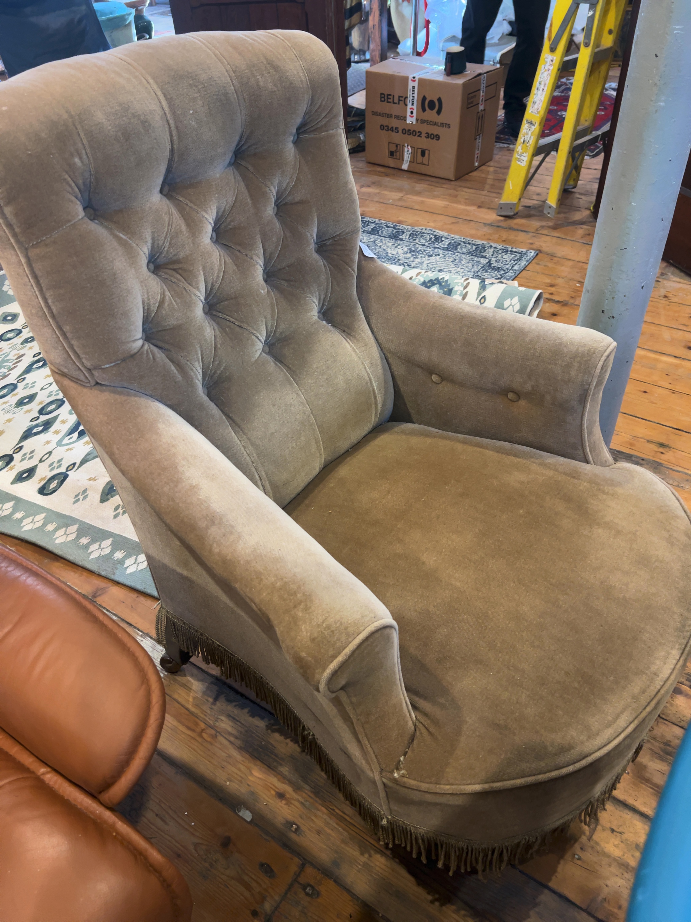 A Velvet-Upholstered Deep-Buttoned Armchair in the Victorian-Style