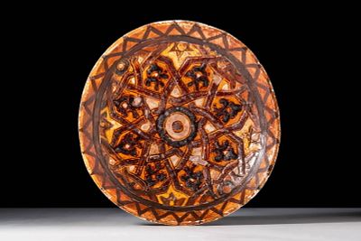 A MAMLUK SGRAFFITO DISH WITH FLOWERS. Egypt, Ca. AD 1300 - 1400. A sgraffito dish of rounded 