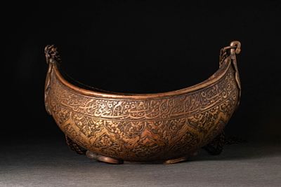 A QAJAR BRASS KASHKUL (BEGGAR'S BOWL). Qajar, Iran, Ca.18th-19th century AD. A brass kashkul of 